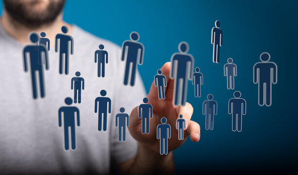 Abstract concept of networking, teamwork, and human connection, represented by a man touching digital avatars. - Powered by Adobe