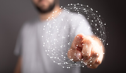 Close up of a man's hand interacting with a glowing digital sphere, representing concepts like networking, global communication and i