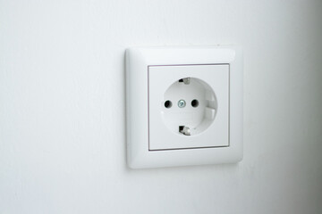 Close up of a European white socket on the wall 