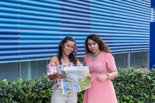 Friends navigating exploring city with paper map