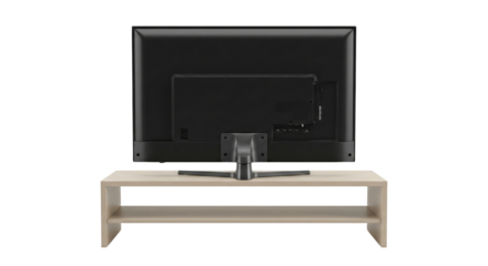 Isolated rear view of a modern flat screen television on a minimalist light wood tv stand