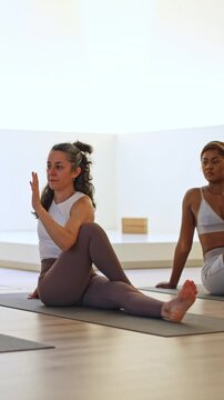 Diverse women stretching in yoga class