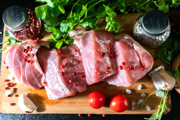 Raw Meat with Tomatoes Garlic and Parsley on Cutting Board