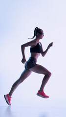Futuristic female sprinter captured in strong mid-stride action. Concept of high-intensity training visuals, sports tech campaigns, dynamic motion studies, and premium fitness content.