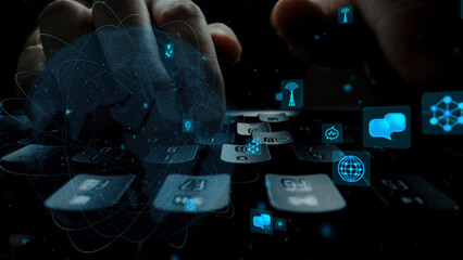 This image features hands typing on a keyboard with floating technology icons, symbolizing digital communication and modern information exchange in a professional setting. Xenic