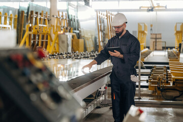 Walking by the glass, quality control. Warehouse worker in an industrial environment of a factory or storage area