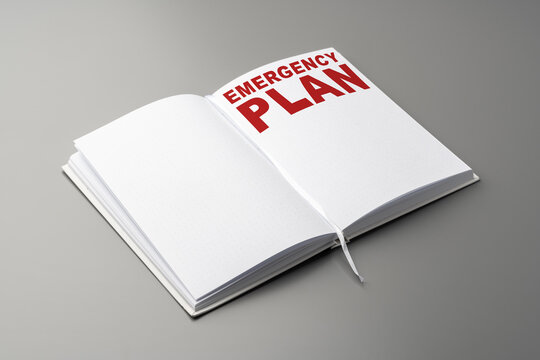 Emergency plan written in a notebook with clear text on a gray background
