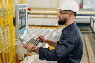 Busy machine operator. Warehouse worker in an industrial environment of a factory or storage area