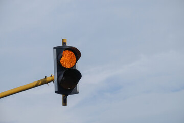 Yellow traffic light indicates caution. Copy space for text. For graphic design, 3D rendering and...