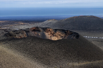 Lanzarote volcanic landscape featuring crater, lava fields, and ocean