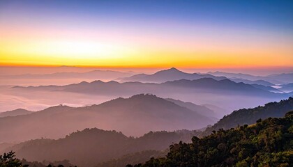 A beautiful landscape of a mountain range at sunrise. The sky is filled with vibrant colors and fog covers the valleys.