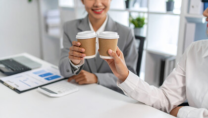 Strategy teamwork collaboration planning solution meeting goal success innovation brainstorming coworkers raise coffee cup office celebrating small victory with documents chart desk and smiling
