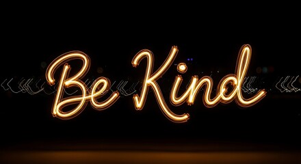 Warm glowing neon sign displaying the positive message be kind in cursive script