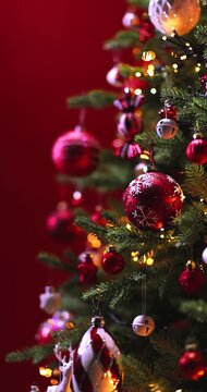 Festive camera movement: decorated Christmas tree with bright lights on a vibrant red background. Perfect for holiday and seasonal content