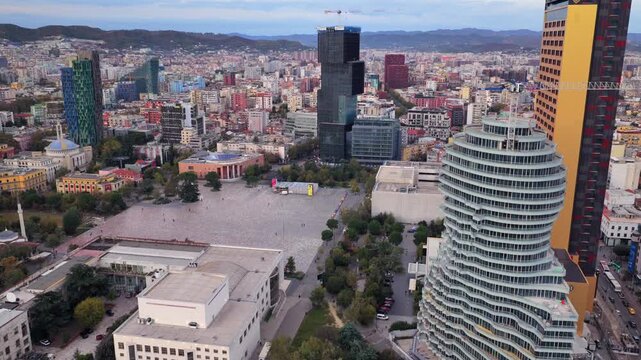 Aerial video of Tirana's Skanderbeg Square surrounded by Modern High Rises. 