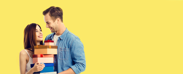 Happy smile cute couple with gift boxes. Holiday sales shopping, consumer credit ad concept. Man...