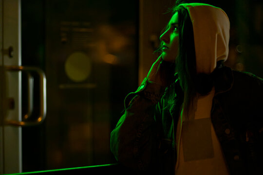 portrait of a girl at night in the dim light of the city
