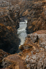 Kolugljúfur Canyon with a waterfall and river surrounded by beautiful rocks,