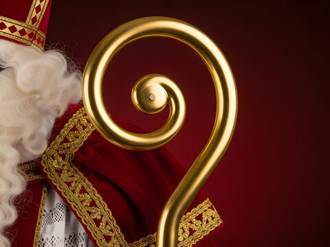  Sinterklaas's golden crozier and traditional red costume, a concept for the Dutch holiday of Saint Nicholas' Day and festive winter celebrations.