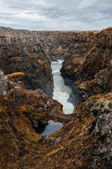 Kolugljúfur Canyon with a waterfall and river surrounded by beautiful rocks,