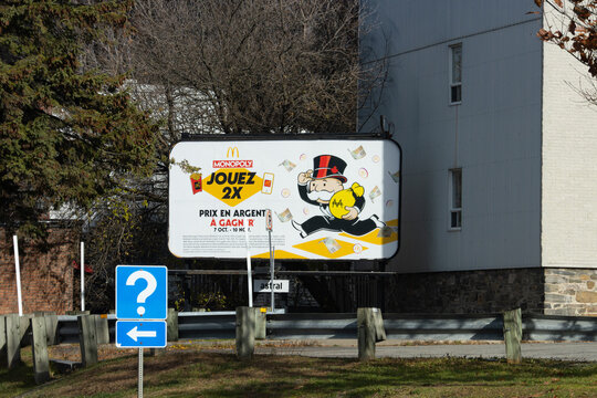 Canada, 08 November 2025 : McDonalds Monopoly advertisement billboard with question mark sign nearby