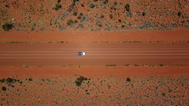 A car driving on a gravel road in the Australian outback, Western Australia
