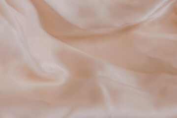 beige silk fabric background with folds