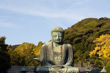 Great Buddha of Kamakura against a clear blue sky, capturing the serene expression of the iconic Daibutsu statue
