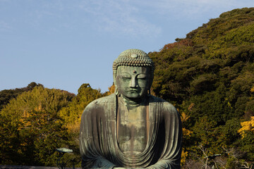 Great Buddha of Kamakura against a clear blue sky, capturing the serene expression of the iconic Daibutsu statue
