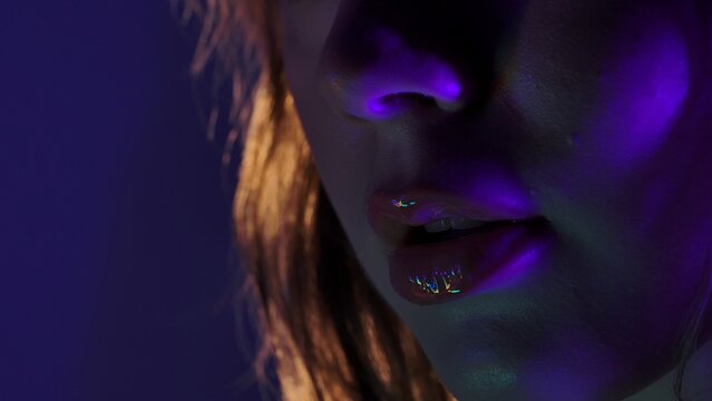 Close up of Glossy Lips in Neon Light Glow