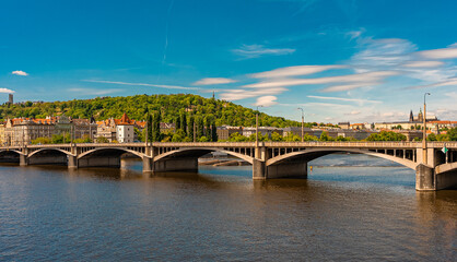 Jirasek Bridge. Modern bridge spanning river with historic city backdrop.