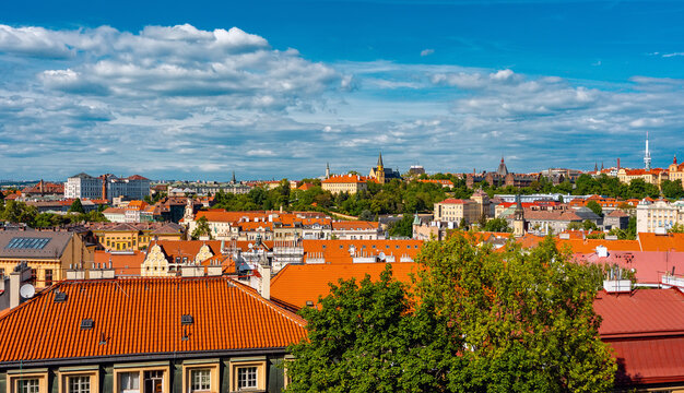 Dense panorama of historic Prague city red roofs and skyline.