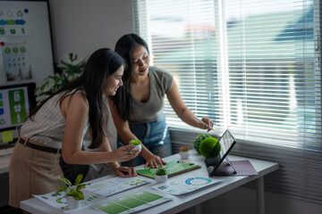Women planning sustainability strategy in modern office