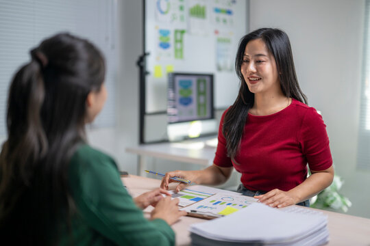 Colleagues collaborating on financial data analysis in office