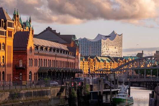 Commercial framing of speicherstadt in hamburg displaying canal flow and waterway clarity against brick architecture that forms the urban historic district under subtle evening light perspective