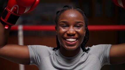 Young boxer celebrates victory with triumphant smile in training ring after intense match - Powered by Adobe