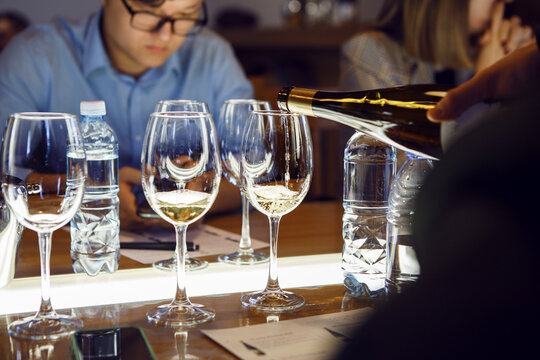 Man Pouring Wine Into Wine Glasses in Sommelier Courses, Close up