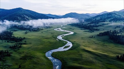 Aerial view of a river winding through a green valley with mountains, trees, and fog. The scene evokes a sense of peace and tranquility.