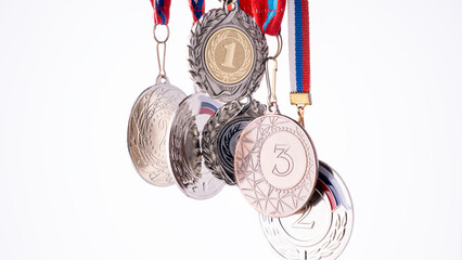 A set of medals, each bearing the numbers 1, 2, and 3. The medals are made of silver and feature a...