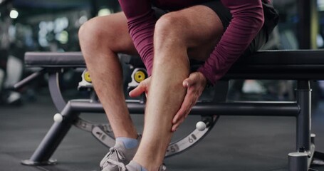 Person, hands and fitness with leg injury for muscle tension, sprain or overworked in gym. Closeup, massage and stretching foot with sore calves or pain for strain, joint inflammation or accident