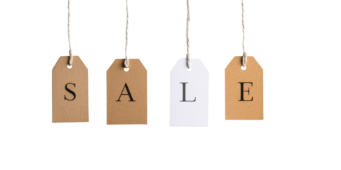 Hanging sale tags on twine string against black background