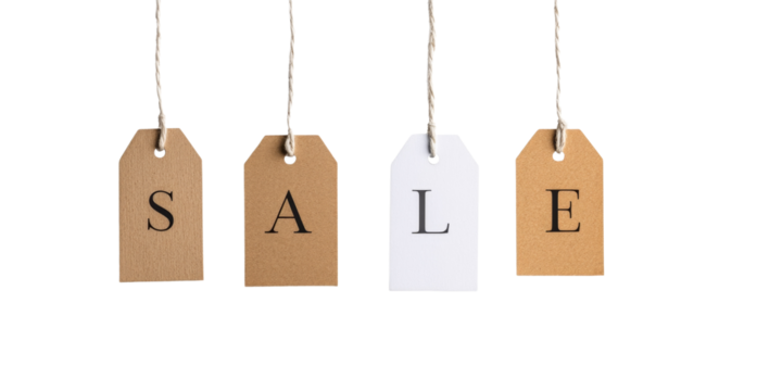 Hanging sale tags on twine string against black background