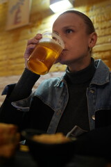 Person drinking beer in cozy cafe