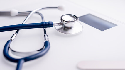 Modern white electronic scales with a stethoscope, scales examining the ratio of body weight of adipose tissue and vestibular adipose tissue. High quality photo