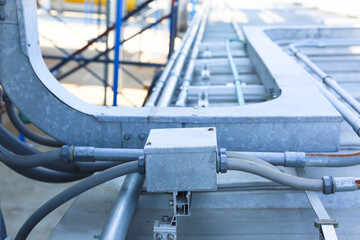 Good manage network electric cable with metal flex pipe. Isolated on white background. Installation of electrical wiring on wall. Electrical cable system installation.