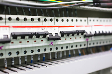 Electric circuit breaker on wall. Power equipment for electrification. Automatic switch for turning on and off high-voltage home appliances. Electric circuit breaker with black switches