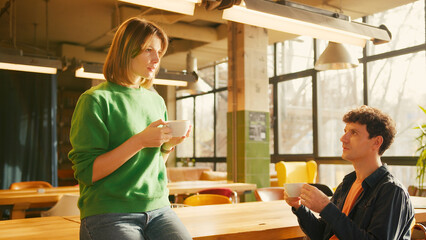 Young couple enjoying coffee and conversation in stylish cafe