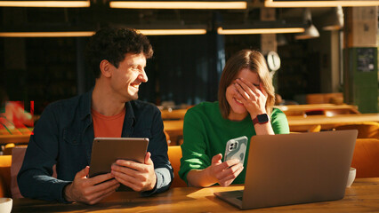 Young students collaborating on project in university library colleagues working in modern coworking