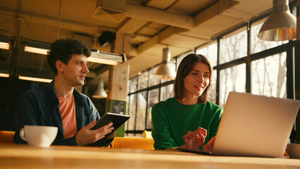Young students collaborating on project in university library colleagues working in modern coworking