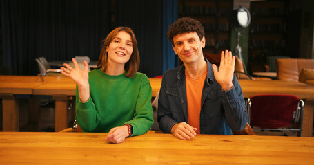 Young couple filming blog or video call looking at camera